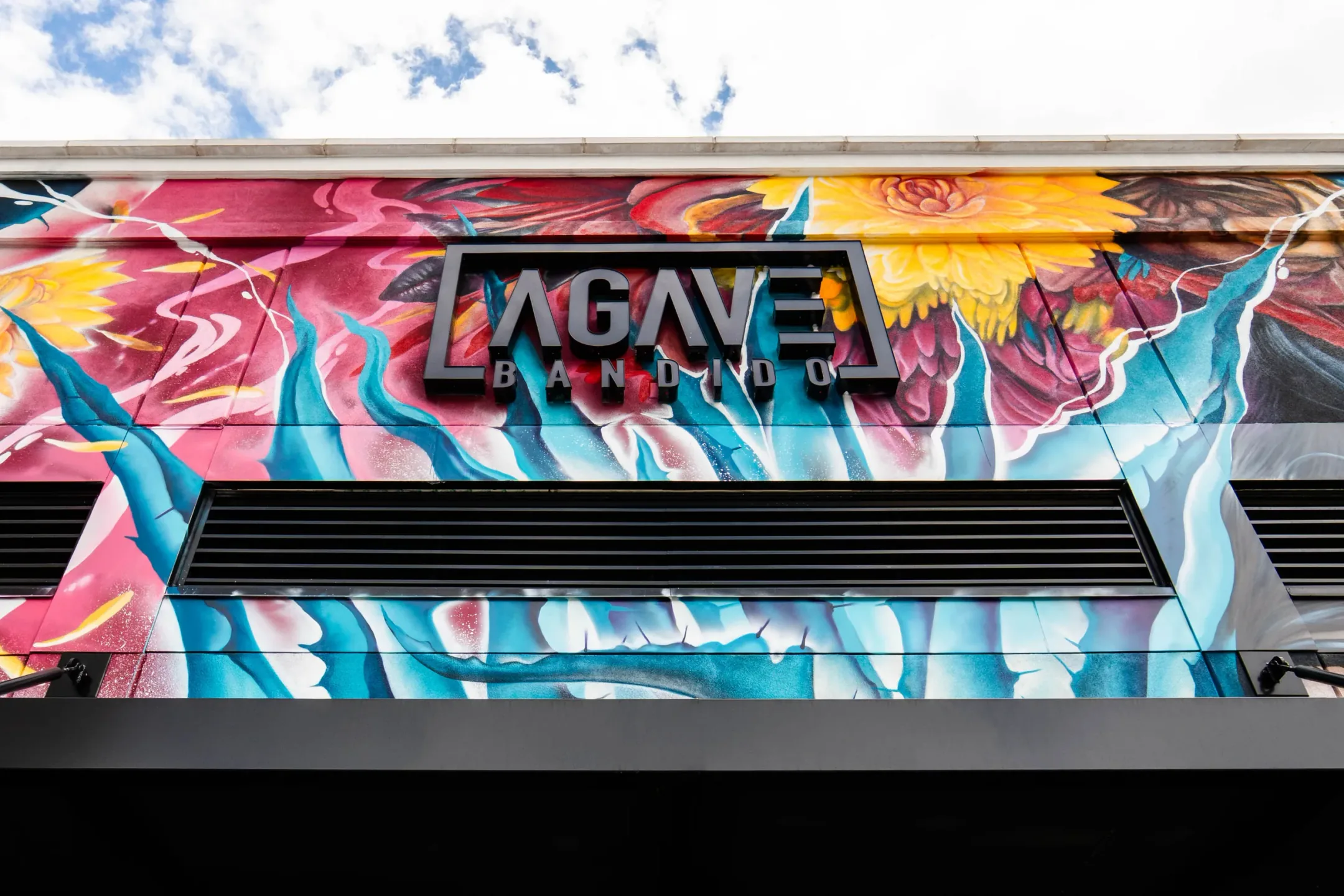 The Agave Bandido storefront, with its logo and mural